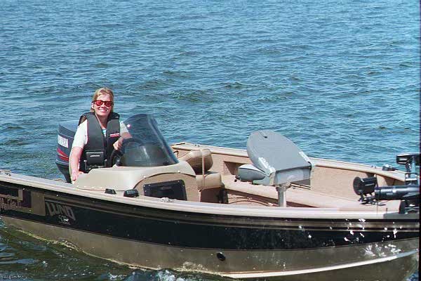 woman driving boat on lake
